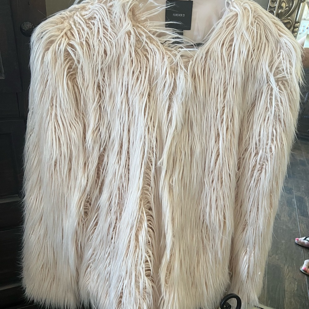 Shaggy fur jacket, color is light pink.  Like new, wore once to Vegas!